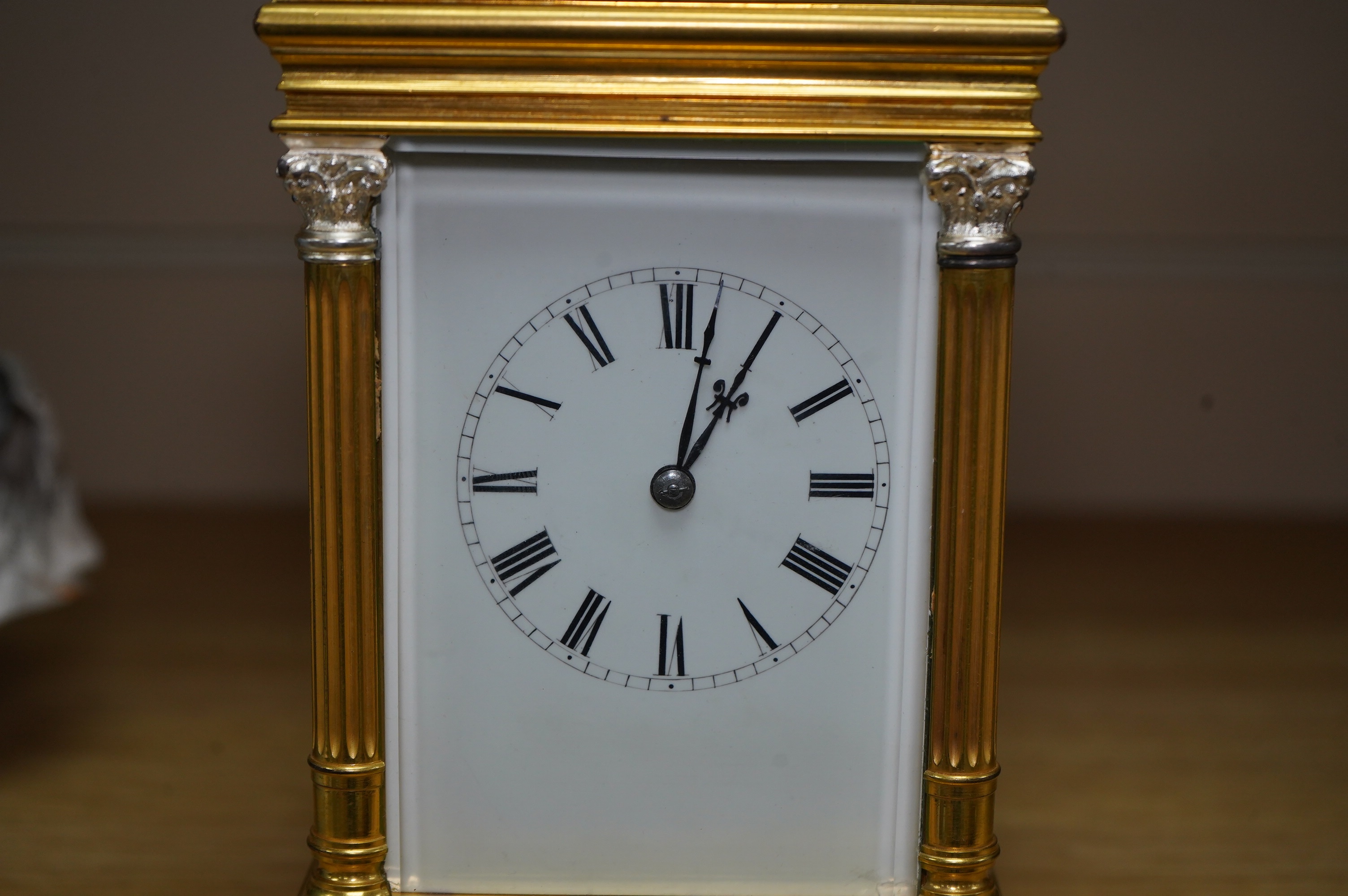 A French silvered and gilt brass hour repeating carriage clock with enamel dial, with key, 20cm high. Condition - good, untested